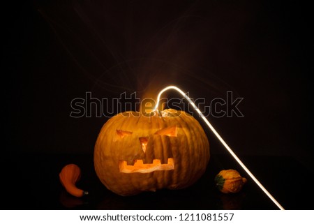 Halloween pumpkin with flash lights isolated on black background.