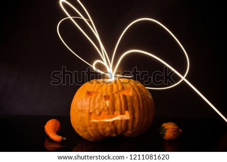 Halloween pumpkin with flash lights isolated on black background.
