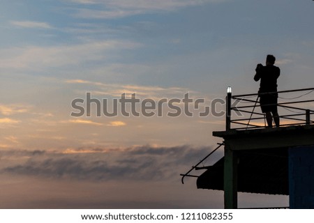 Man taking pictures of a beautiful sunrise in the morning.