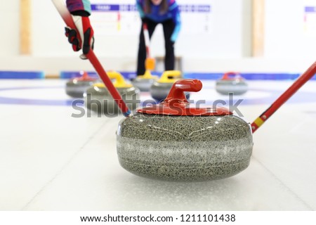 Granite curling stones.Curling on the ice. Team curling game.
 Royalty-Free Stock Photo #1211101438