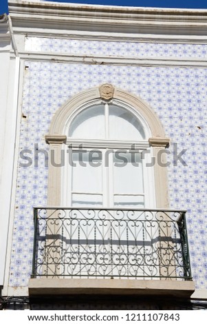 Traditional Portuguese building with a small balcony in the old town, Tavira, Algarve, Portugal, Europe.