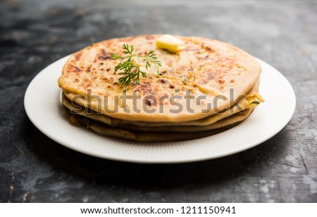 Aloo Paratha / Indian Potato stuffed Flatbread. Served with fresh curd and tomato ketchup. selective focus Royalty-Free Stock Photo #1211150941