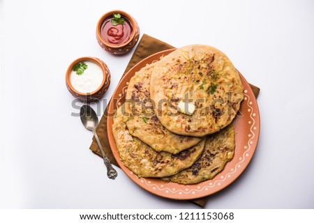 Aloo Paratha / Indian Potato stuffed Flatbread. Served with fresh curd and tomato ketchup. selective focus Royalty-Free Stock Photo #1211153068