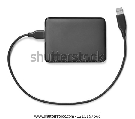 External hard disk with cable, isolated on white background. Small modern hard drive, PC security.