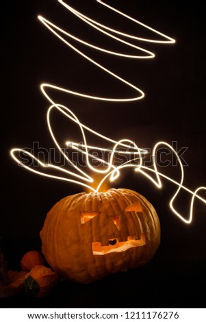Halloween pumpkin  with flash lights isolated on black background.