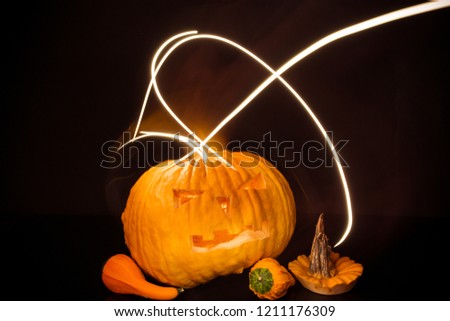 Halloween pumpkin  with flash lights isolated on black background.