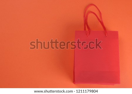 Black Friday. The concept of shopping. Sale. Package for shopping on an orange background with a place for an inscription.