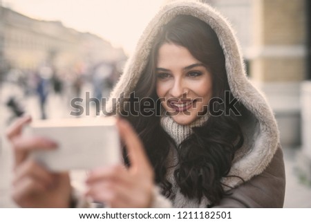 Close up of woman using tablet while standing on the street. 