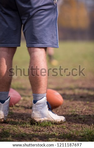 american football kicker practicing football kickoff closeup shot