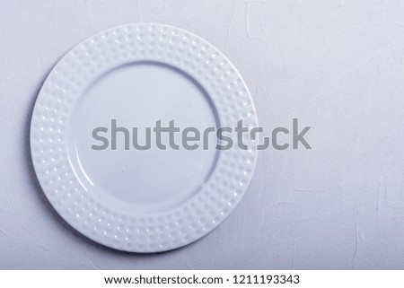 Empty gray plate on wooden table . Top view background
