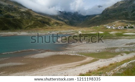 Spluegenpass with the Monte Spluga , and Lago di Montespluga, reservoir and surrounding mountains in summer 
