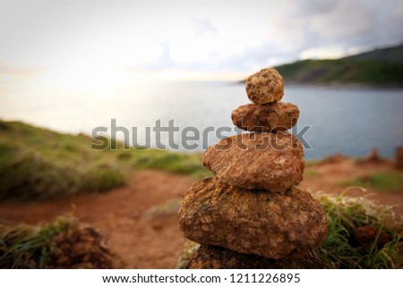 Balanced stone pyramid on shore  water of ocean That is the background
