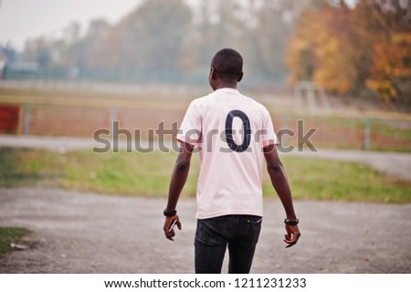 African american man in pink football sport t-shirt with zero number.