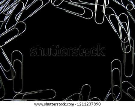 Paper clips and space for text  on black blackground