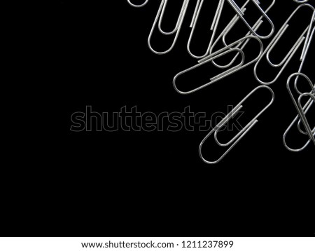 Paper clips and space for text  on black blackground