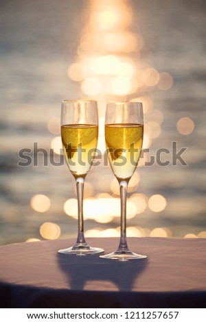 Two glasses of champagne at sunset
