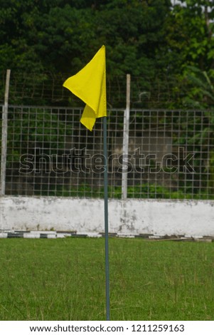 A yellow corner flags around a sports ground isolated unique photo
