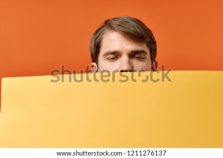 man looks out because of yellow mockup                       