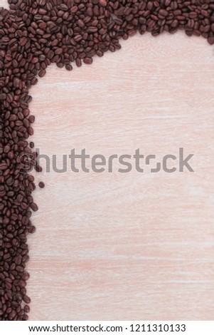 wooden background with black coffee beans .photo with copy space