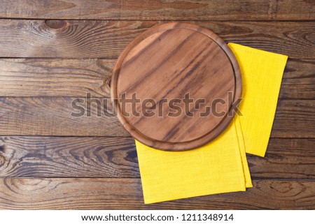 wooden pizza desk and yellow tableclothes on table, food concept,mock up