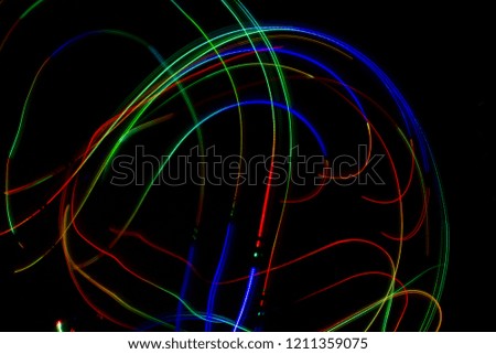Colorful Light Painting Photography With Parallel Lines, Waves And Curves Against A Black Background