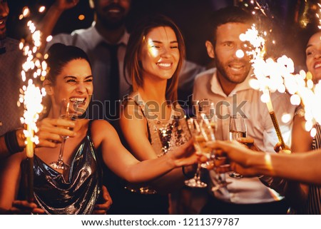 Group of friends celebrating with champagne