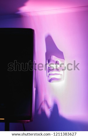 music speaker and part of the face on the wall