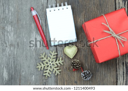 Red gift box and christmas decoration equipment on wooden floor and have copy space for design your work concept.