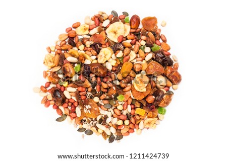 Different nuts, candied fruits, dried grapes, apricots, dates are in the shape of a circle on a white background. Healthy useful food for adults and children