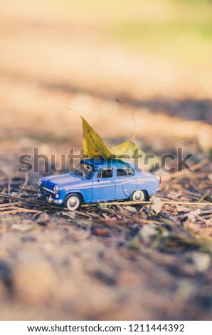 Chernigiv, Ukraine. October 09, 2018. Little model toy of retro car in the autumn forest. Selective focus, toned image