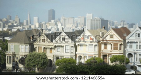 Beautiful row houses with Victorian architecture and downtown skyline 