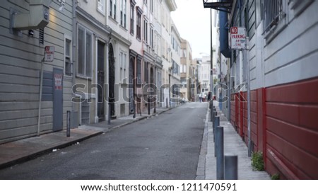 Background plate of silver car driving in charming alley in San Francisco