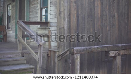 Background plate of rickety wood cabin in Auburn, California, an historical mining town. Backdrop for compositing of old wooden house with front porch and stairs. 4k
