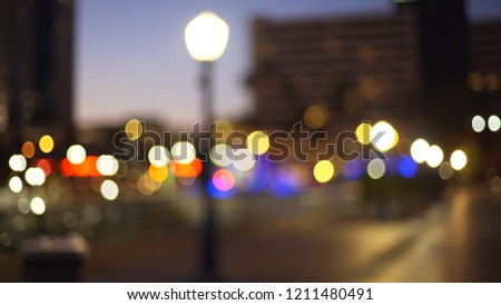 Background plate of bokeh city lights with streetlamp on sidewalk downtown