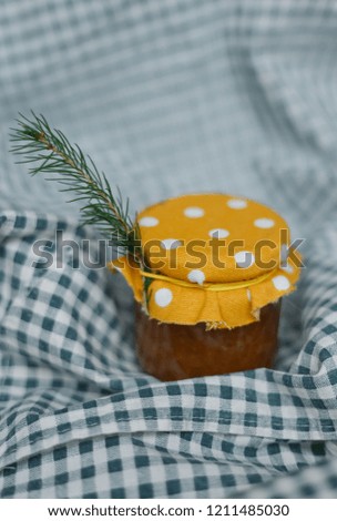 Jam in a jar on a checkered tablecloth