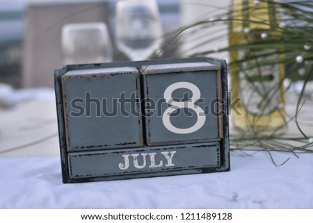 Wood blocks in box with date, day and month 8 July. Wooden blocks calendar