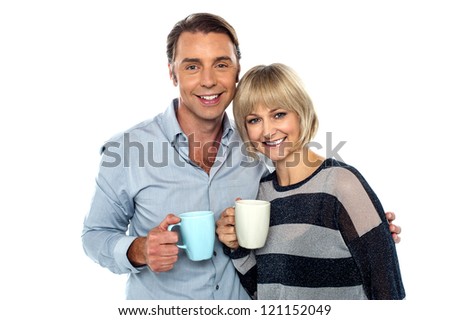 Couple starting their day with a cup of coffee. Cherishing it together.