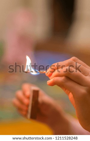 The child lighting the matches. The fire in the hands of a child. vertical photo