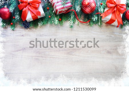 Christmas frame made of fir branches, red and golden decorations, gift boxes and pine cones on white wooden table. Christmas background. Flat lay. top view with copy space