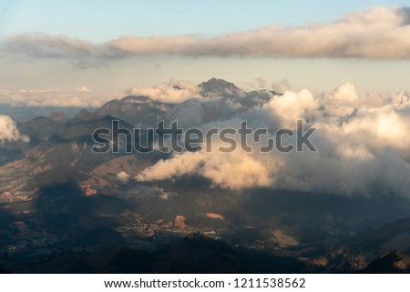 Scenic mountain landscape with beautiful clouds, green rainforest and rocky peaks, Três Picos Park, countryside of Serra do Mar, Rio de Janeiro State, Brazil