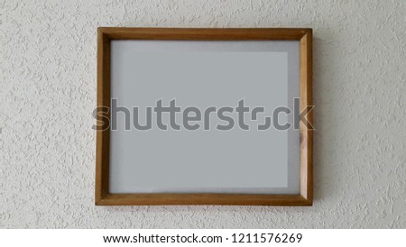Wooden frame. Empty wooden picture frame on light wall
