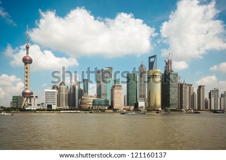shanghai skyline against a blue sky