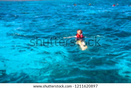 Beautiful blurred blue sea bathing game. Ocean theme with people for background. Stock photo for tourist design