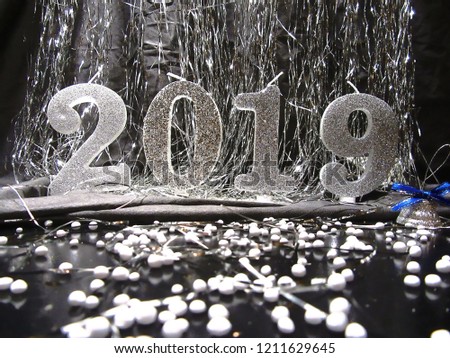 Light happy new year 2019 background. Festive, christmas background with shiny candles and white ball, Candles and numbers 2019 on festive background
