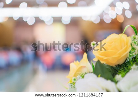 Abstract blurred of conference hall or seminar room photo with flowers foreground and background
