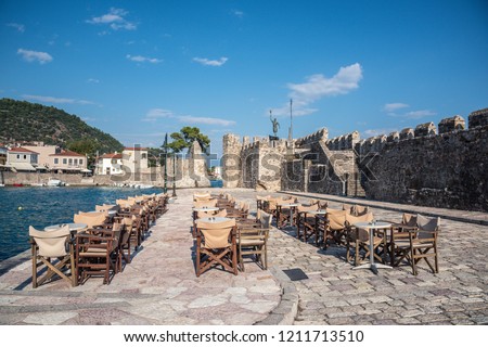 Empty outdoor cafe by the harbour, Nafpaktos, Mainland Greece
