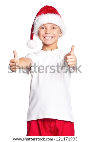 Portrait of happy teen boy in Santa hat with thumbs up isolated on white background
