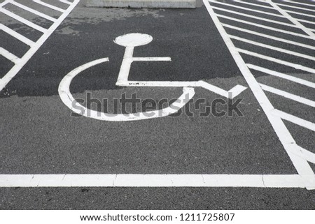 Handicapped parking reserved for the disabled in outdoor lot for the public


