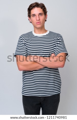 Young handsome man with wavy hair against white background