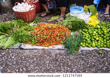 Freshly harvested vegetables and herbs sold in the street morning markets of Luang Prabang, Laos 